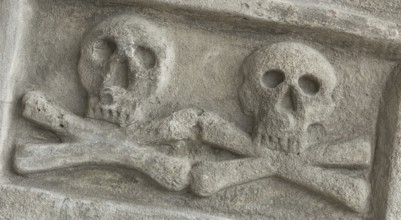 Ancient stone skull with crossbones. Old sculpture. Ideal for concepts and backgrounds