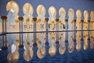 Beautiful gallery of famous Sheikh Zayed White Mosque in Abu Dhabi, UAE. Reflections at sunset