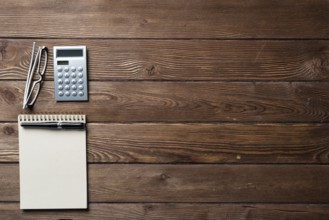 Still life of accountant workspace with office accessories. Flat lay wooden desk with elegant