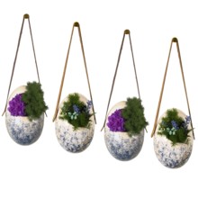 Four hanging planters with speckled design filled with flowers showcasing artistic decor