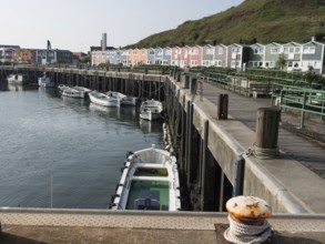 Small harbour with boats and colourful houses along a jetty, Heligoland, North Sea, Germany, Europe