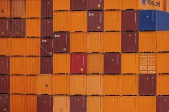 Close up view of stacked orange and red containers in a harbour, rotterdam, the netherlands
