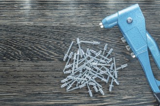 Riveting pliers stainless screws on wooden board
