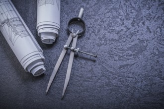 Construction plans pair of compasses on black background maintenance concept