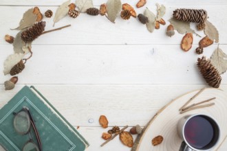 Vintage book and drink in retro mug on wooden background. top view with space for text