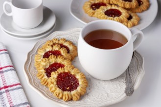 Cookies with jam and a cup of tea served for breakfast