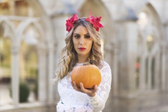 Portrait of fairy tale queen holding a pumpkin