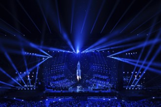 Futuristic-looking concert stage, illuminated in blue with a central rocket motif, Il Volo concert,