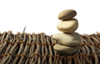 Stacked stones on wooden base. White isolated