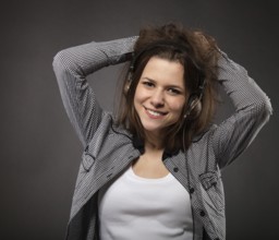 Portrait of the brunette beauty smiling girl wearing headphones