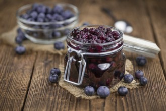 Fresh made Blueberries (preserved) on an old and rustic wooden table, selective focus, close-up