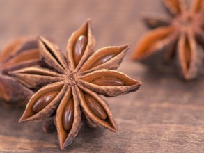Star anise on wooden background close up with copy space
