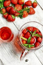 Glass decanter with delicious strawberry compote of fresh berries