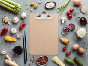 Asian ingredients and empty clipboard. Various of Chinese cooking ingredients and chopsticks on