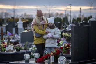 A profoundly touching and heartfelt moment between a mother and daughter at a cemetery, honoring