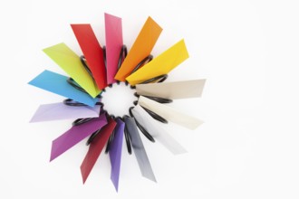Propeller of colored envelopes on the white table