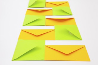Composition with yellow and green envelopes on the white table