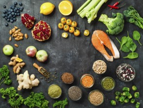 Clean Eating concept with copy space in center. Selection food ingredients for Clean Eating on dark