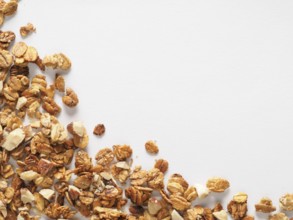 Homemade granola isolated one edge on white background. Ingredient for healthy breakfast. Copy