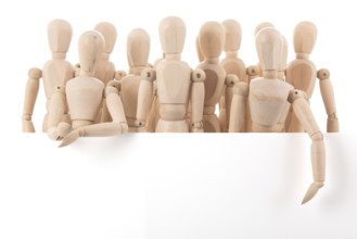 Many wooden mannequins behind board isolated over white