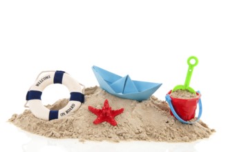Beach with life buoy and toys in the sand isolated over white background