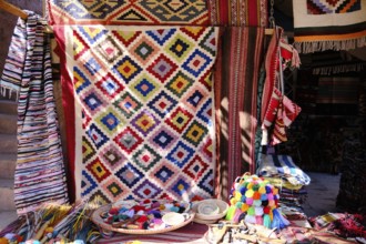 Traditional colorful berber hand woven wool carpets and rugs at middle eastern bazaar. Berber