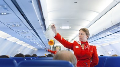 MOSCOW - MAY 28, 2011: Air hostess Yulia of Aeroflot shows how to use an oxygen mask on board.