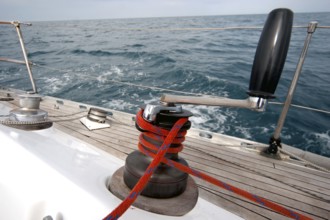 Winch with rope on sailing boat in the sea