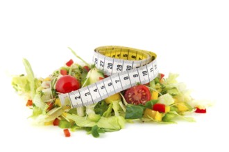 Fresh healthy mixed salad with measuring tape