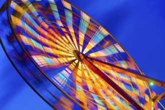 Turning illuminated ferris wheel shot at long exposure