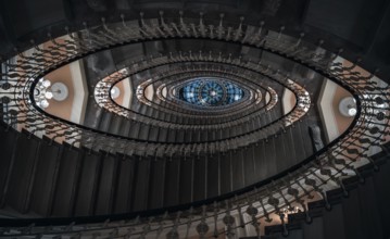 Eye-catching image with staircase design in a spiral form, a pattern of oval figures, illuminated