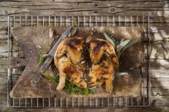 Presentation of a marinated chicken with herbs and baked in the oven