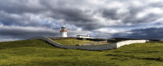 A view of the historic harbor lighthouse at St. John's Point in Donegal Bay in the north of Ireland