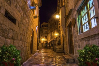 Narrow street of Old Town in Kotor at night