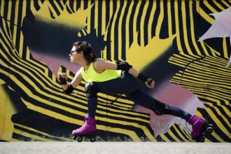 Photo shoot of the moment when a young girl is doing gymnastics with roller skates