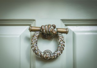 Ornate Brass Door Knocker On A Mint Green Door In Middle England