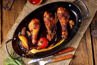 Grilled chicken legs in a barbecue marinade with sweet potatoes