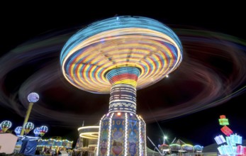 Merry go round, Carousel spinning fast creating wonderful light trails at an amusement park