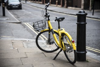 Yellow bicycle parked on the streets of London