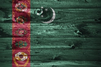 Turkmenistan flag on wooden planks background wood flag