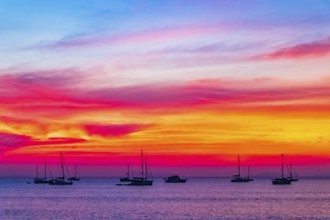 Yachts boats in front of the most beautiful colorful sunset at Tropical Paradise island Koh Phayam