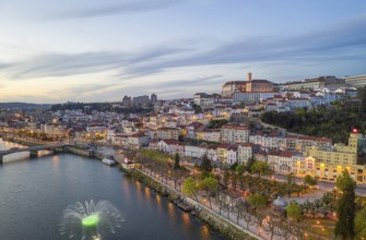 Coimbra drone aerial city view at sunset with colorful fountain in Mondego river and beautiful