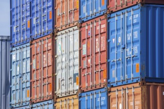 Stacked colourful freight containers at the container terminal in Holz-und Fabrikenhafen, Bremen,