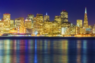San Francisco sunset skyline in California with reflection in bay water USA