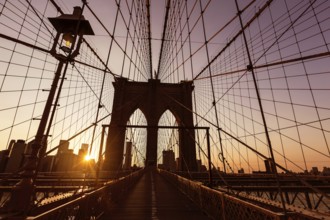 Brooklyn Bridge sunset with Manhattan skyline of New York City USA