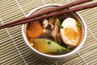 Ramen egg noodle soup dish with salmon fish