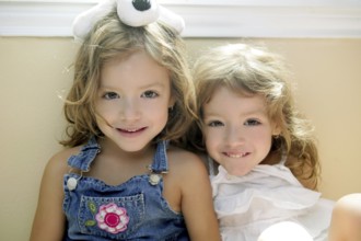 Two little beautiful toddler twin sisters portrait