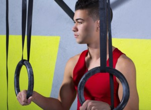 Crossfit dip ring young man relaxed after workout at gym dipping exercise