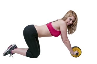 Beautiful woman using an ab wheel