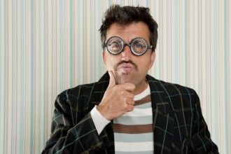 Nerd silly myopic man with glasses thinking doing funny gesture with retro mustache